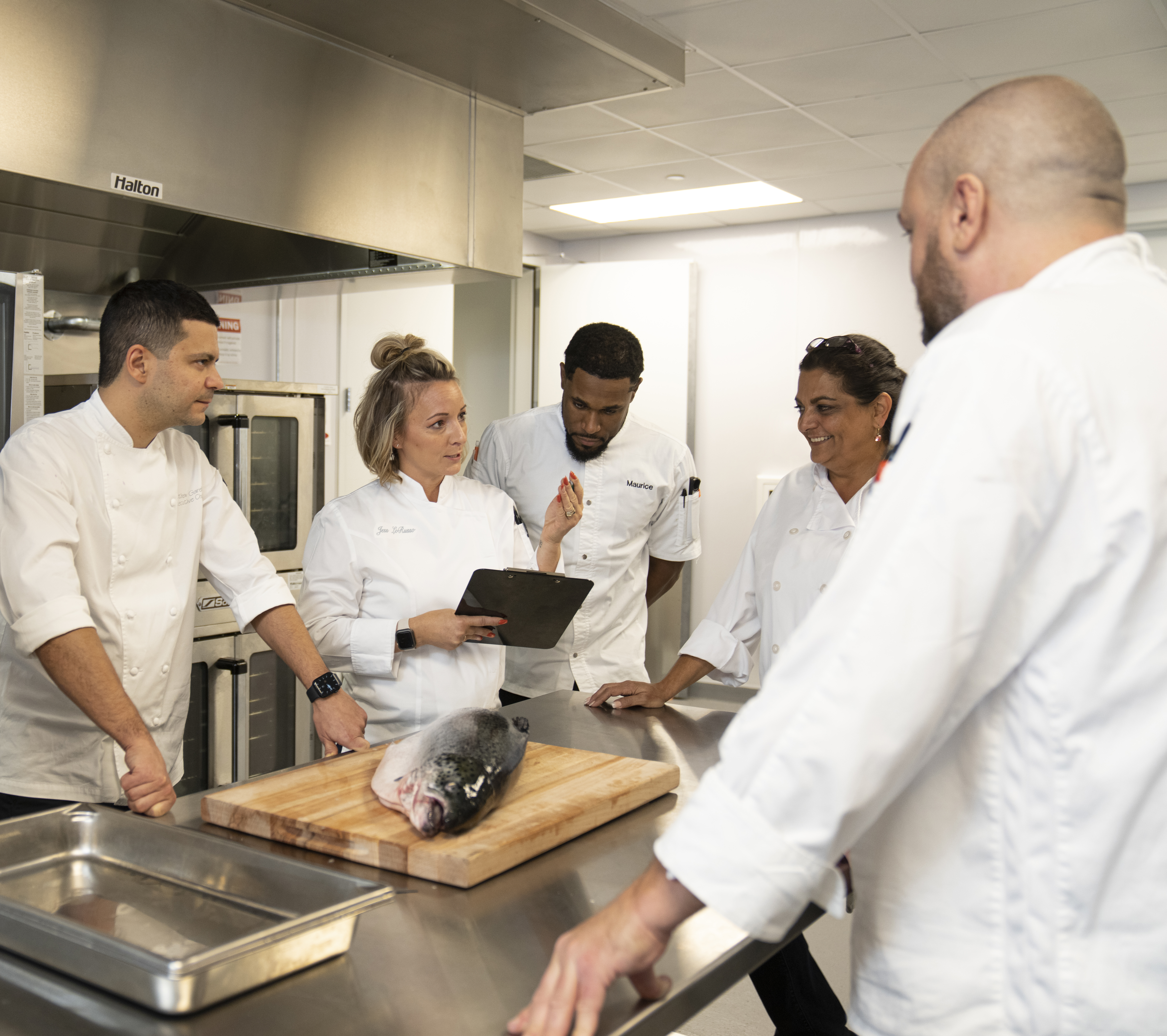 Chefs preparing fresh fish 